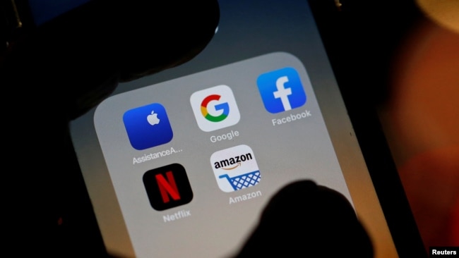 Description: The logos of mobile apps, Google, Amazon, Facebook, Apple and Netflix, are displayed on a screen in this illustration picture taken December 3, 2019. REUTERS/Regis Duvignau