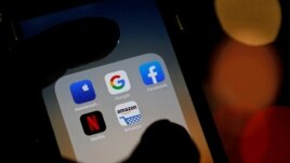 Description: The logos of mobile apps, Google, Amazon, Facebook, Apple and Netflix, are displayed on a screen in this illustration picture taken December 3, 2019. REUTERS/Regis Duvignau