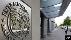 International Monetary Fund logo is seen outside the headquarters building during the IMF/World Bank spring meeting in Washington, U.S., April 20, 2018. REUTERS/Yuri Gripas - RC13CB8CD000