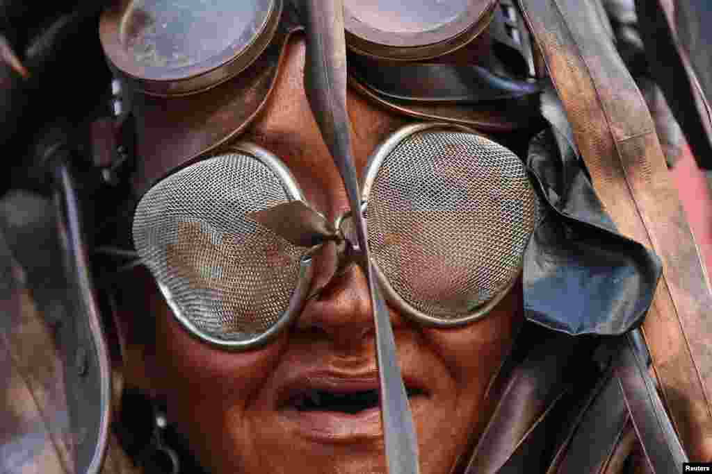 A performer takes part in an unveiling of a billboard against fracking in central London, Britain.