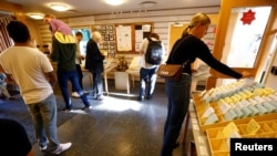 People pick ballot papers at a polling station during a general election in Stockholm, Sweden, Sept. 9, 2018. 