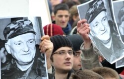 FILE - Citizens of Sarajevo protest in front of the building of the EU Special Representative office building in Sarajevo, to show support for retired General Jovan Divjak, March 5, 2011.