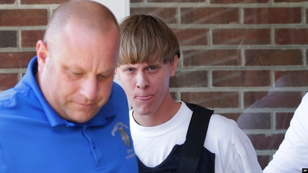 Charleston, S.C., shooting suspect Dylann Storm Roof, center, is escorted from the Shelby Police Department in Shelby, North Carolina, June 18, 2015.