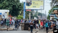 Protesters fill the street as police deploy in Maputo, Mozambique, Nov. 7, 2024. 