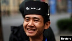 A hotel employee smiles at the Metropole Hotel ahead of the North Korea-U.S. summit in Hanoi, Vietnam, Feb. 27, 2019. 