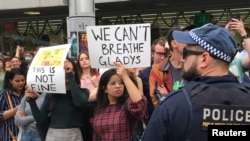 People take part in a climate protest at Sydney's Town Hall, Australia, Dec. 11, 2019. 