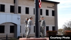 Members of a flag detail lower the flag in front of the Norma Brown Building on Goodfellow Air Force Base, Texas, March 16, 2018. (Airman 1st Class S. Hines / USAF)