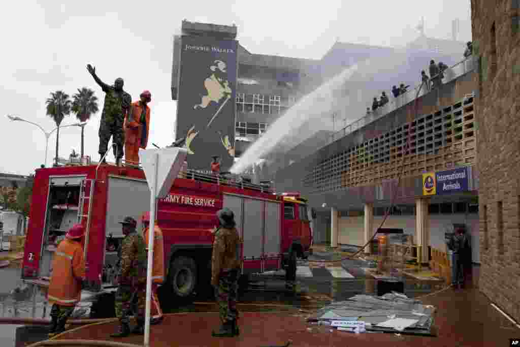 Firefighters put out the fire at the Jomo Kenyatta International Airport, Nairobi, August 7, 2013.