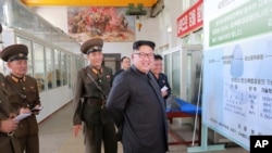 North Korean leader Kim Jong Un smiles during a visit to the Chemical Material Institute of the Academy of Defense Science in this undated photo released by North Korea's Korean Central News Agency in Pyongyang on Aug. 23, 2017.