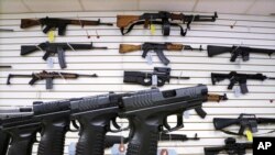 FILE - Assault weapons and hand guns are seen for sale at Capitol City Arms Supply in Springfield, Ill.