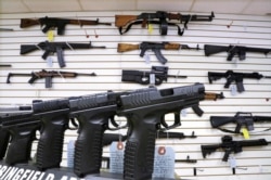 FILE - Assault weapons and handguns are seen for sale at Capitol City Arms Supply in Springfield, Ill.