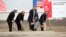 FILE - From left US Vice Admiral James D Syring, Romanian President Traian Basescu , US Undersecretary of Defense for Policy James N Miller, and Romanian Defense Minister Mircea Dusa shovel sand during the official ground breaking ceremony of an U.S. Aegis Ashore missile defense base in Deveselu, Romania, Oct. 28, 2013.
