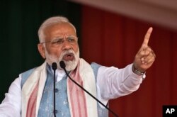 Indian Prime Minister Narendra Modi addresses a public rally in Changchari, on the outskirts of Gauhati, India, Feb. 9, 2019.