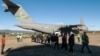 Guatemalan migrants walk from a U.S. military plane after being deported from U.S. at the Guatemalan Air Force Base in Guatemala City, Jan. 24, 2025. (Handout photo/Guatemalan Migration Institute/AFP