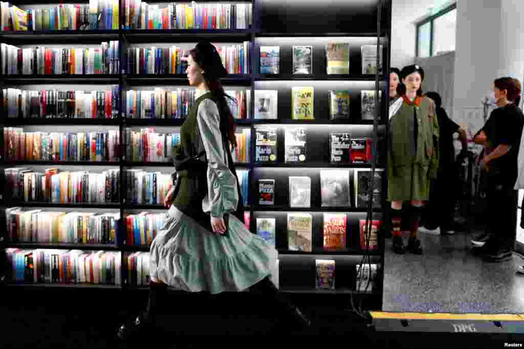 Models present creations during a livestreamed Autumn/Winter 2020 collection show held inside a bookstore with no audience during China Fashion Week in Beijing, China, May 6, 2020.