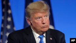 FILE - U.S. President Donald Trump attends a press conference at the Elysee Palace in Paris, July 13, 2017.