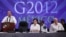 Mexico's President Felipe Calderon, left, delivers a speech during the G20 foreign ministers summit in Los Cabos, Mexico, Feb. 20, 2012