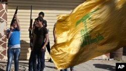 Hezbollah supporters fire weapons as they celebrate the fall of the Syrian town of Qusair to forces loyal to President Bashar Assad and Hezbollah fighters, in Bazzalieh village, Lebanon, near the Lebanese-Syrian border, June 5, 2013. 