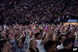 Concertgoers watch on during Taylor Swift's "The Eras Tour," Dec. 6, 2024, in Vancouver, British Columbia.