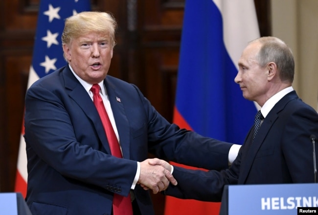 U.S. President Donald Trump and Russia's President Vladimir Putin shake hands after their joint news conference in the Presidential Palace in Helsinki, Finland, July 16, 2018.