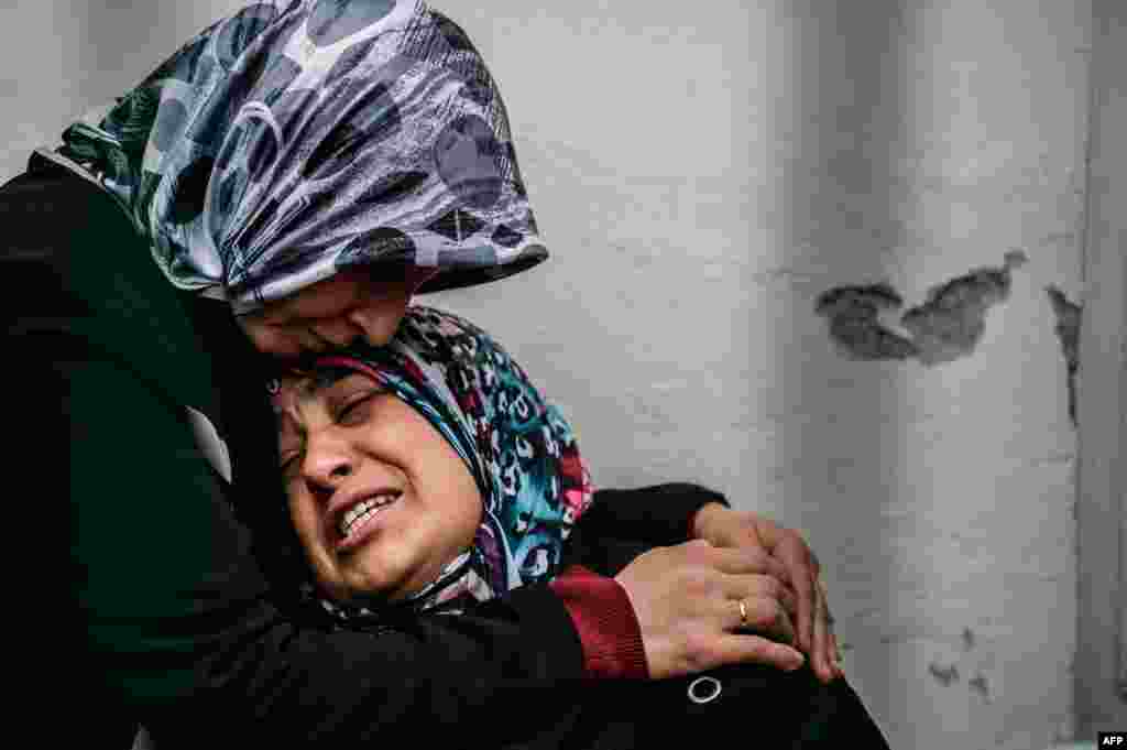 A mother of a victim cries as she waits for the body of her son at the forensic building in Ankara the day after a suicide car bomb ripped through a busy square in central Ankara killing 37 people and wounding 125, officials said.