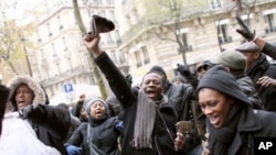 A man waves his cap during a demonstration in front of the Ivorian Embassy in Paris, 04 Dec 2010