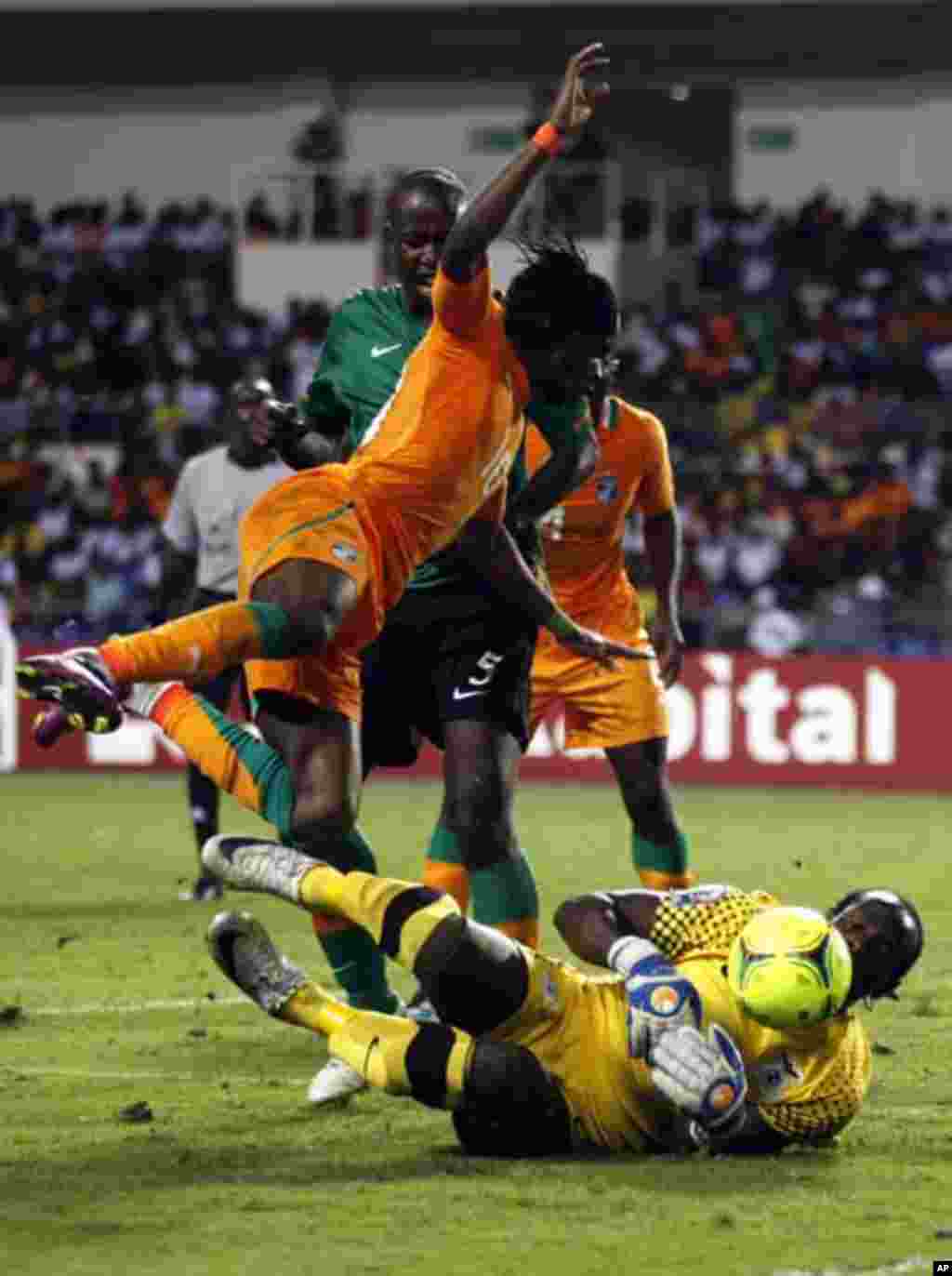 Ivory Coast's Gervinho (10) falls over Zambia's goalkeeper Kennedy Mweene (16) as he tries to score during their African Nations Cup final soccer match at the Stade De L'Amitie Stadium in Gabon's capital Libreville, February 12, 2012.