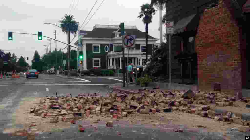 Bricks are in the street after a building was damaged during an earthquake in Napa, California, Sunday, Aug. 24, 2014. 