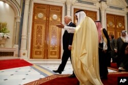 FILE - President Donald Trump walks with Saudi King Salman at the Gulf Cooperation Council Summit, at the King Abdulaziz Conference Center, May 21, 2017, in Riyadh. Despite reported CIA findings that Saudi Crown Prince Mohammed bin Salman personally ordered the killing of Saudi journalist Jamal Khashoggi, Trump maintains that Saudi Arabia is a "great ally in our very important fight against Iran."