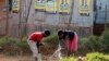 Children collect water from a communal tap beneath election posters for President Jacob Zuma's African National Congress (ANC) in Bekkersdal township south of Johannesburg, May 3, 2014. 