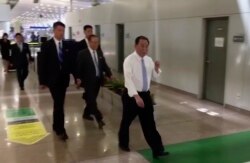 FILE - In this image made from video, Kim Yong Chol, in white, a former military intelligence chief who is now Kim Jong Un's top official on inter-Korean relations, walks upon arrival at Beijing airport in Beijing, May 29, 2018.