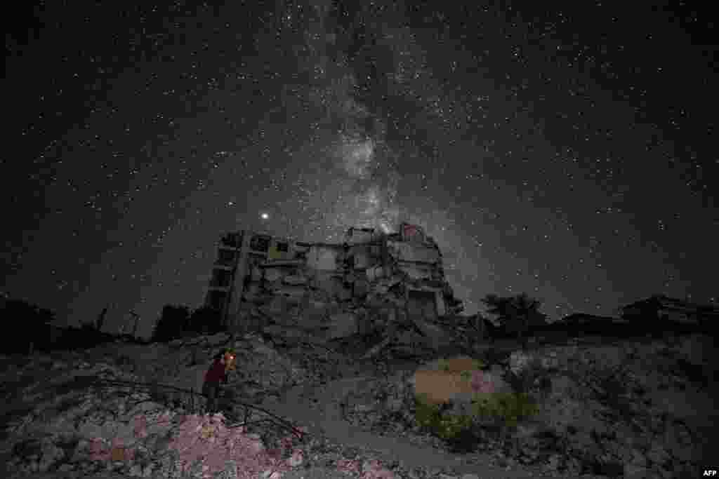 The ruins of Ariha in Syria&#39;s rebel-held northwestern Idlib province are lit by the Milky Way, June 27, 2020.
