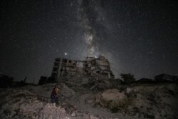 The ruins of Ariha in Syria's rebel-held northwestern Idlib province are lit by the Milky Way, June 27, 2020.