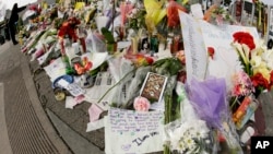Flowers and notes are left at a makeshift memorial near the site of a warehouse fire, Dec. 7, 2016. Recovery efforts at the site have ended officials said Wednesday. 