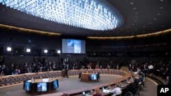 NATO leaders attend a plenary session during a NATO summit at NATO headquarters in Brussels, where the 30-nation alliance hopes to reaffirm its unity and discuss increasingly tense relations with China and Russia.