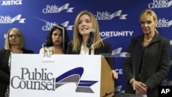 Kathryn Eidmann, a staff attorney at Public Counsel, at podium, speaks at a news conference announcing a lawsuit charging gender discrimination in the California workers' compensation system on July 6, 2016, in Los Angeles. 