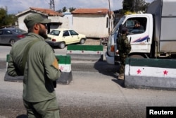 Members of Syrian security forces man a checkpoint at the entrance of Latakia, after hundreds were killed in violence that pitted loyalists of deposed President Bashar al-Assad against the country's new Islamist rulers, in Syria, March 10, 2025.