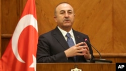 Turkish Foreign Minister Mevlut Cavusoglu, and Jordanian Foreign Minister Ayman Safadi (not shown), give a press conference in Amman, Jordan, Feb. 19, 2018. Cavusoglu said his country is ready to battle Syrian government troops if they enter an enclave in northern Syria to protect Syrian Kurdish fighters. 