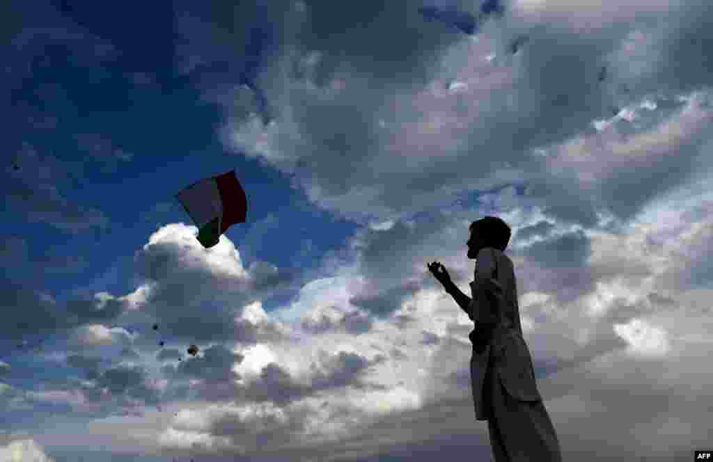 An Afghan youth flies a kite, a weekly Friday pastime, on the Nadir Khan hilltop overlooking Kabul.