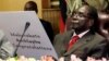 Former Zimbabwe's President Robert Mugabe reads a card during his 93rd birthday celebrations in Harare, Feb. 21, 2017. 