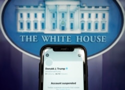 A photo illustration shows the suspended Twitter account of U.S. President Donald Trump on a smartphone at the White House briefing room in Washington, D.C., Jan. 8, 2021.