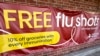 FILE - A sign for flu vaccination is displayed outside of a grocery store in Glenview, Illinois, Feb. 15, 2024.