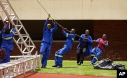 Workers erect stands ahead of Friday's presidential inauguration of Emmerson Mnangagwa, at the National Sports Stadium in Harare, Zimbabwe, Nov. 23, 2017.