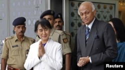 Burma's opposition leader Aung San Suu Kyi at the Indira Gandhi international airport where she was greeted by India's Foreign Secretary Ranjan Mathai (R), New Delhi, November 13, 2012.