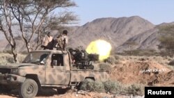 FILE - Houthi fighters fire a machine gun mounted on a truck at a frontline in al-Jubah district of Yemen's Marib province in a frame grab from video handed out by the Houthis' media center. Nov. 2, 2021.