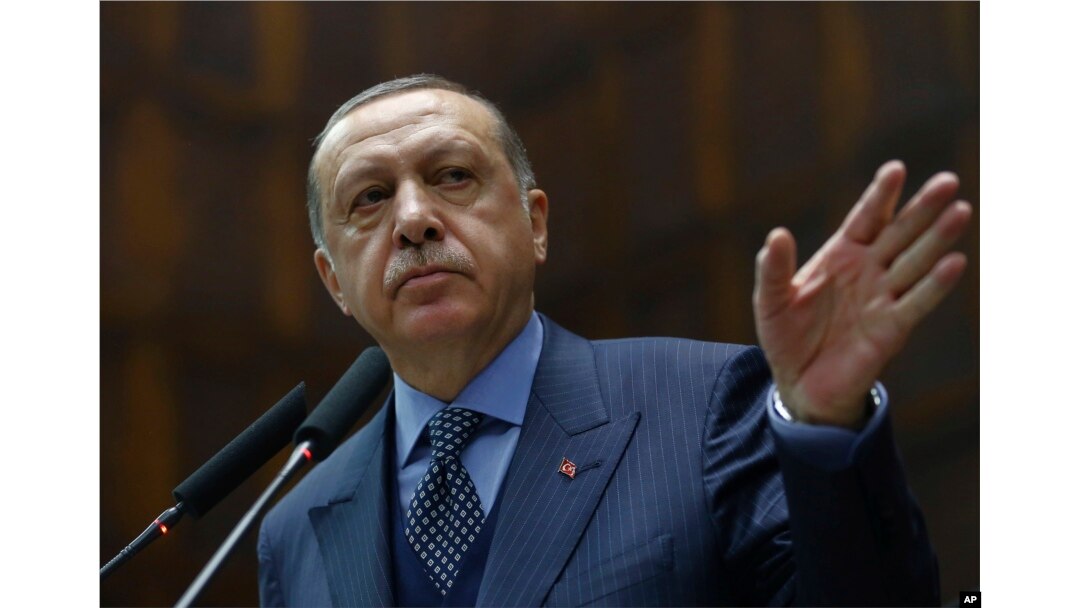 FILE - Turkey's President Recep Tayyip Erdogan addresses his supporters at the parliament in Ankara, Turkey, Nov. 28, 2017.