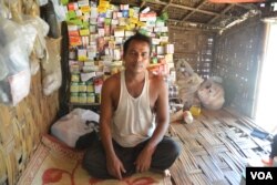 Ayub Khan, a displaced Rohingya man, sits in his family’s UN shelter from where he sells medicine to residents in Baw Du Pha Camp 1 outside Sittwe. (P. Vrieze for VOA)