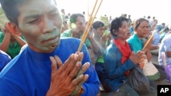 Cambodian villagers affected by the loss of land in Prey Lang forest in the north of the country pray at a Buddhist shrine in central Phnom Penh, August 18, 2011. 