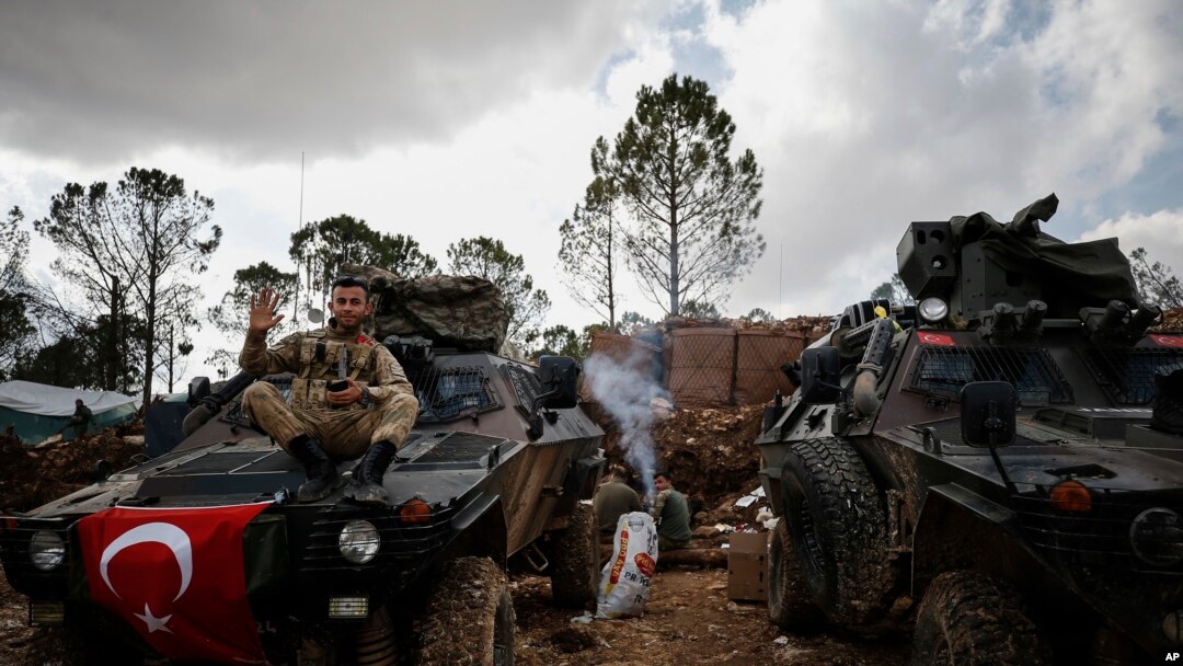 FILE - A Turkish soldier is seen atop the Bursayah hill in Syria's Afrin district, March 3, 2018. Since Turkey took control of Afrin, rights groups and Kurdish activists have accused Turkey and its allies of settling Arab and Turkmen families in the predominately Kurdish region. 