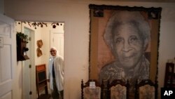 FILE - NY Nathiri walks through the Moseley House Museum, the restored home of Matilda Clark Moseley, niece of town founder Joe Clark and best friend of author Zora Neale Hurston, in Eatonville, Florida,.August 23, 2023.